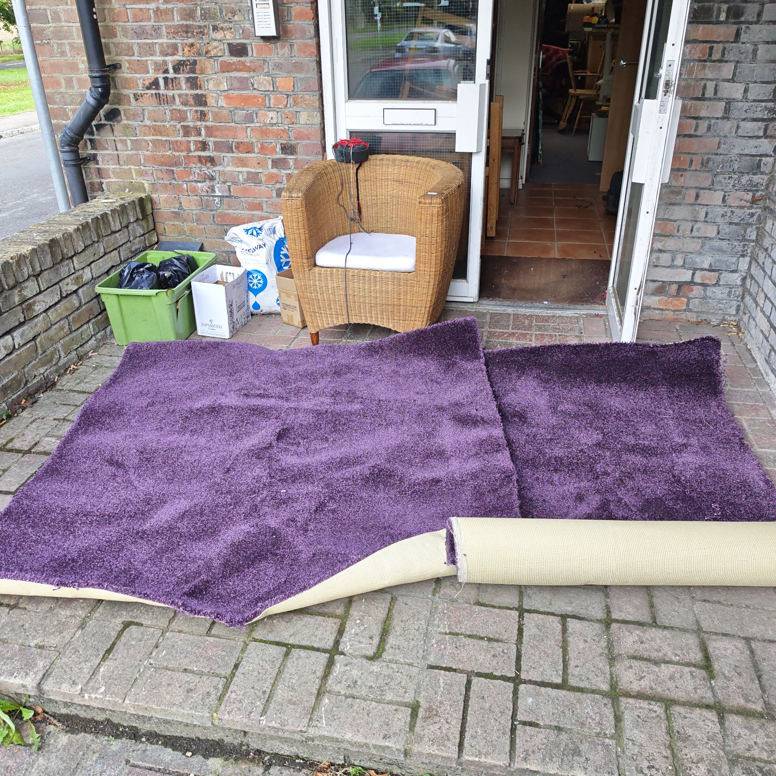 Two purple off cuts of carpet