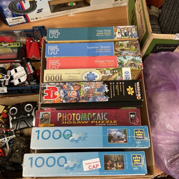 Box of puzzles including corner piece, some sealed