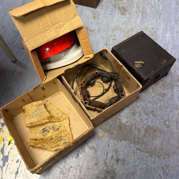 Vintage Lucas alternator coil with Brownie camera and fire alarm.
