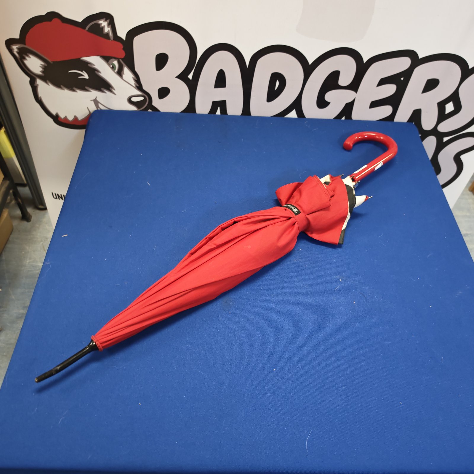 Red Lulu Guinness umbrella, a stylish fashion accessory.