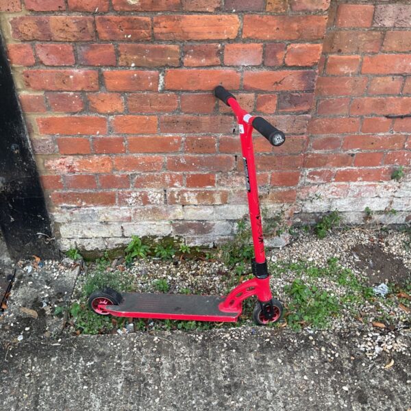 Red Madd Gear Pro stunt scooter for freestyle riding.