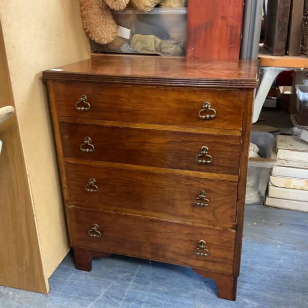 Small mahogany mid-century chest of drawers with four drawers.