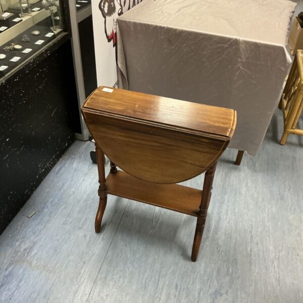 Antique mahogany folding table with drop leaf and tripod legs.