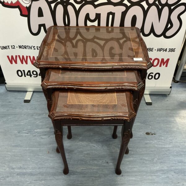 Vintage mahogany nest of tables with glass tops.