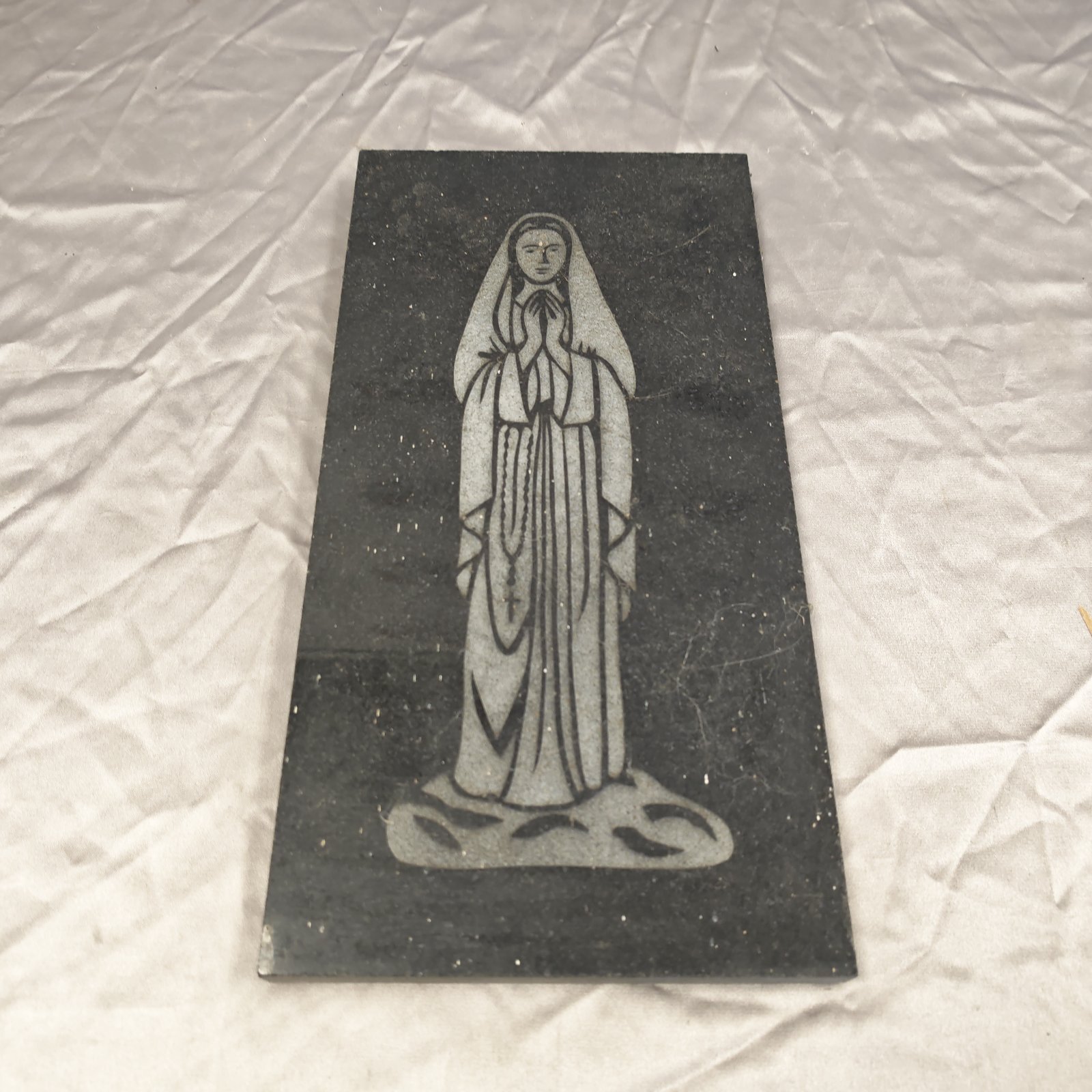 Detailed granite stone plaque of the Virgin Mary.