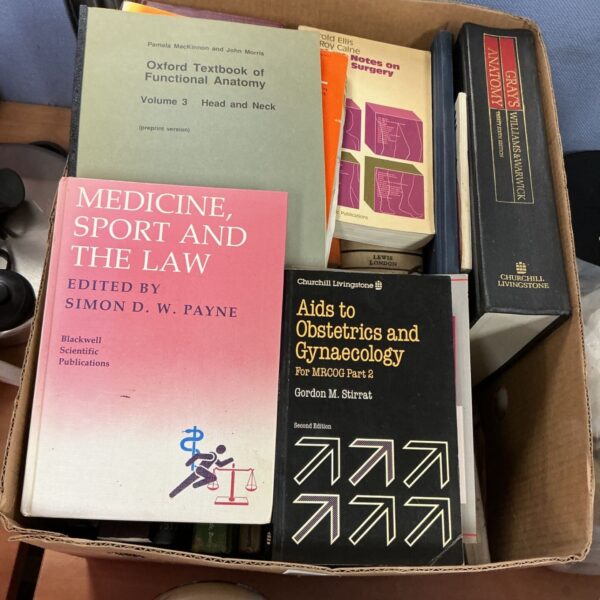 Stack of vintage medical reference books for study.