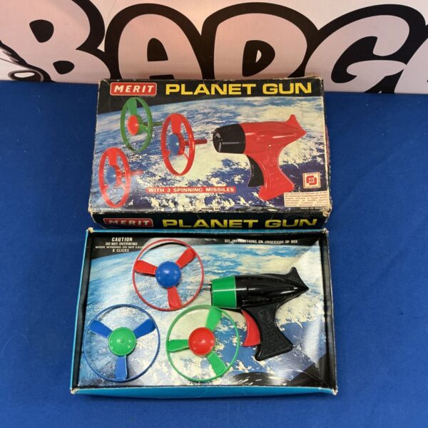 Vintage Merit Planet Gun with spinning missiles, a retro space toy.