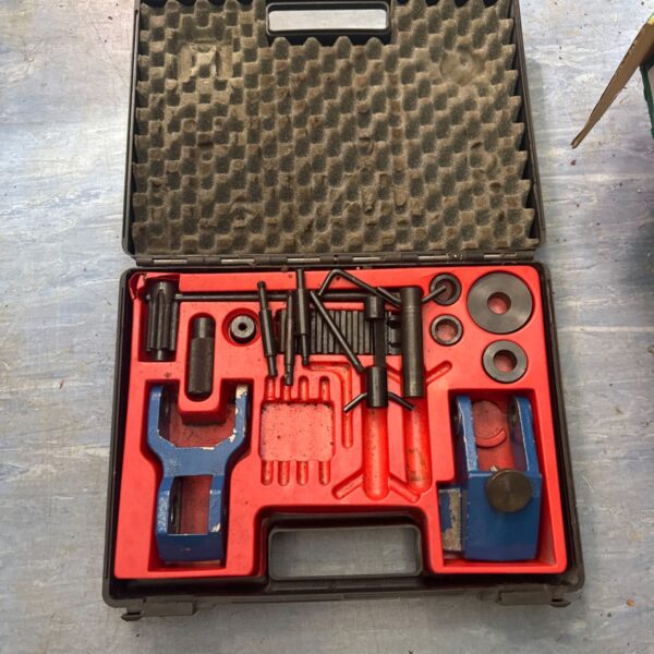 Open metal bending set in a black carrying case.