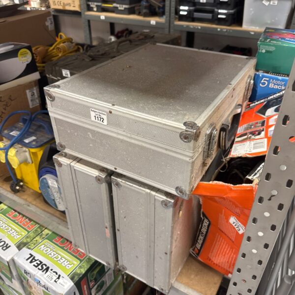 Stack of three metal flight cases for equipment protection.