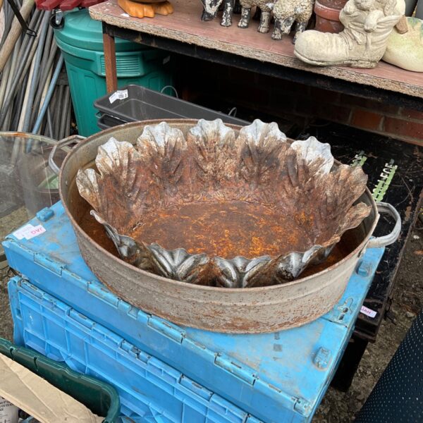 Vintage metal garden planters with a ridged design, rustic garden decor.