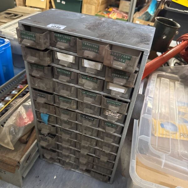 Vintage metal organiser cabinet filled with various parts and components.