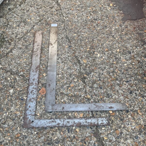Vintage metal set squares for drafting and technical drawing.