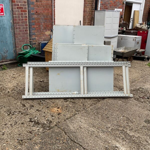 Heavy duty metal shelving unit in a garden setting.