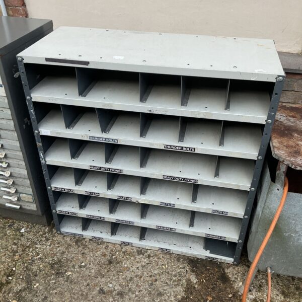 Metal storage unit with multiple bins for workshop organisation.