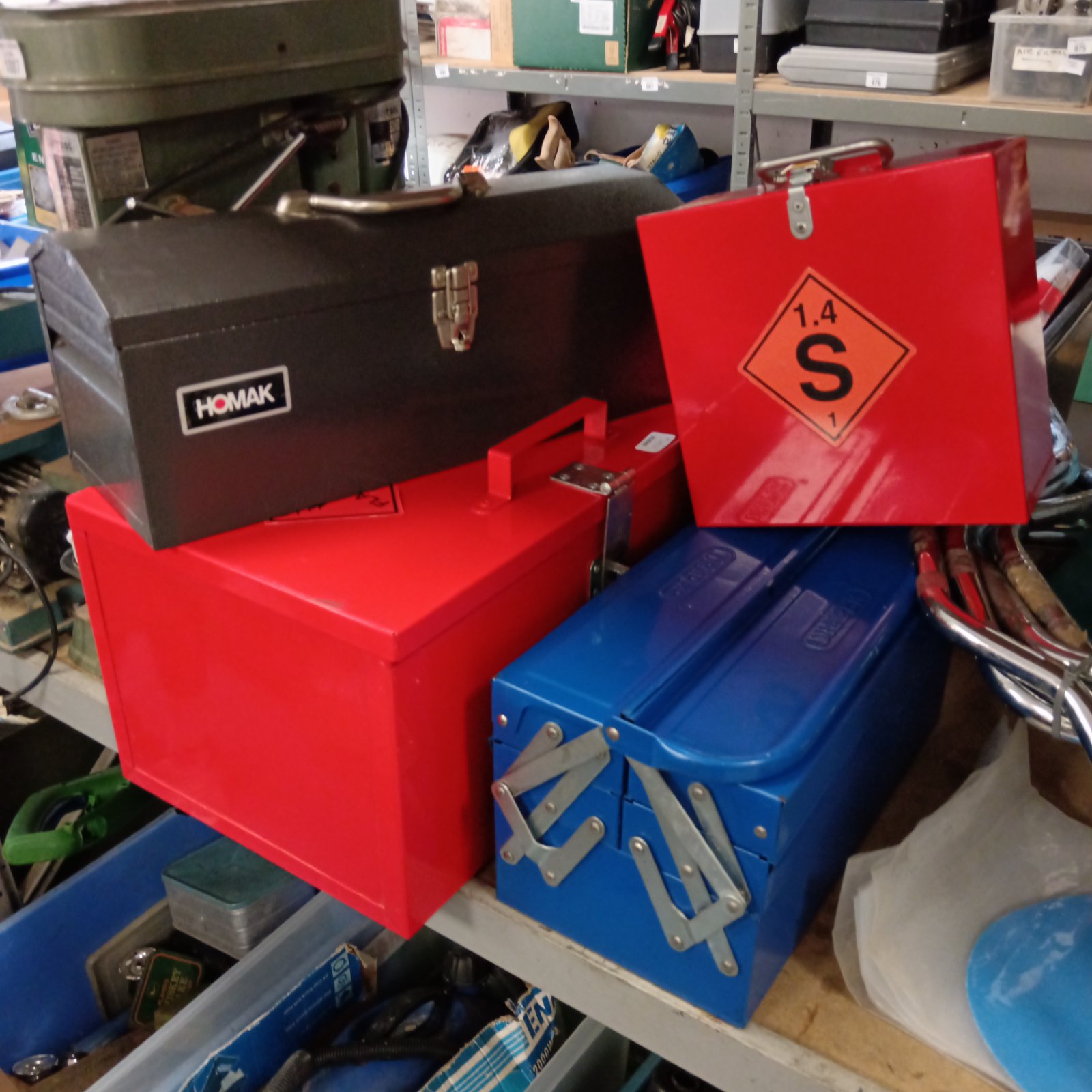 Vintage metal toolboxes and chemical cabinets for workshop storage.