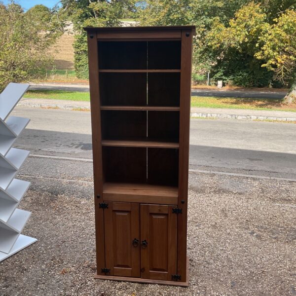Rustic Mexican pine bookcase with cabinet doors and open shelving.