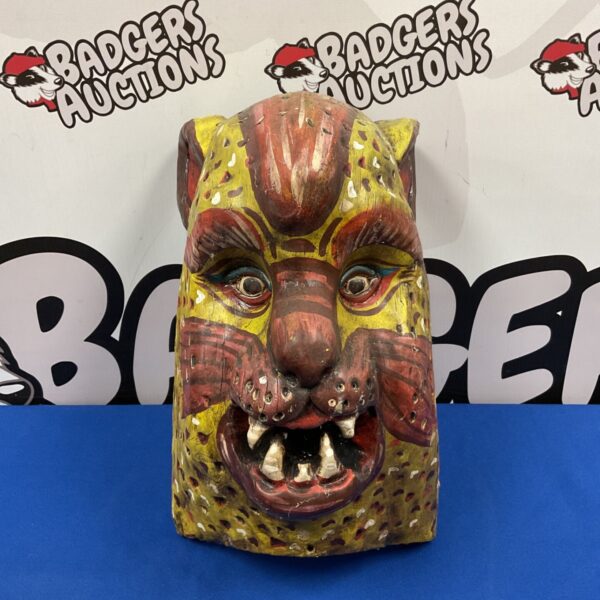 Vintage Mexican tiger mask with detailed carving and vibrant paint.