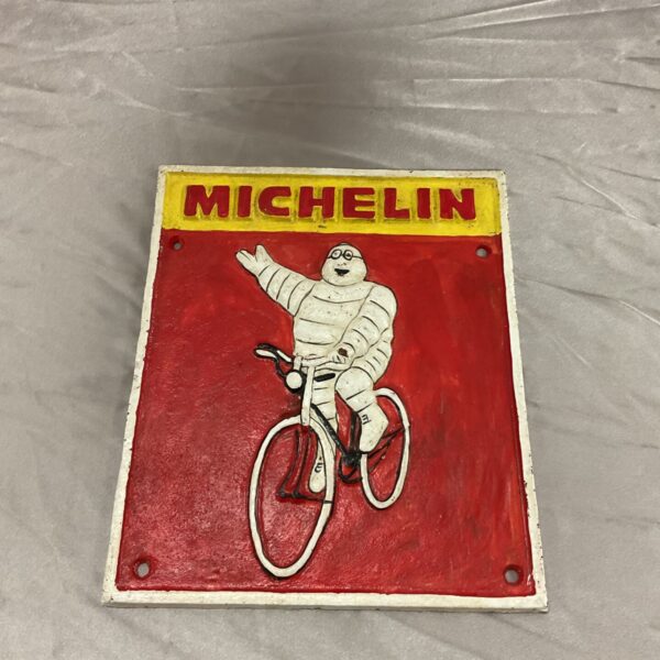 Vintage cast iron Michelin Man wall plaque, classic advertising sign.