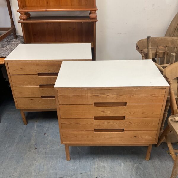 Pair of mid-century modern chests of drawers with white tops.