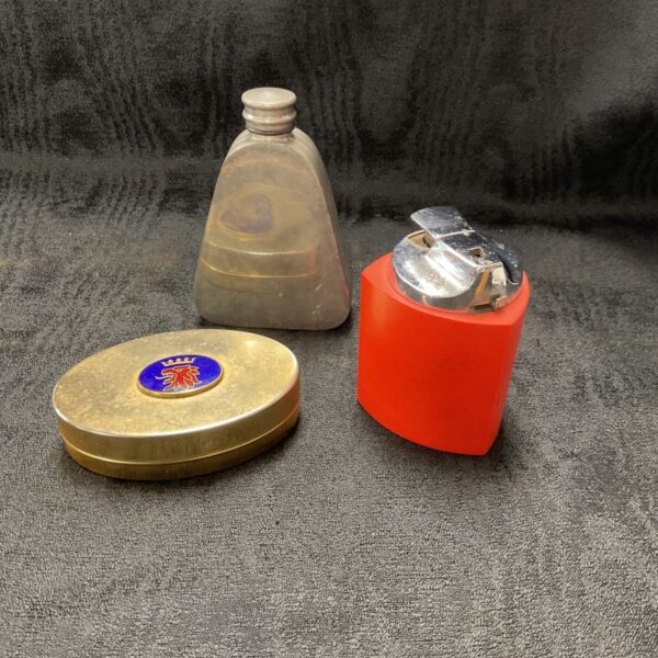Mid-century collectibles lot featuring Ronson lighter, pewter flask, and Saab tin.