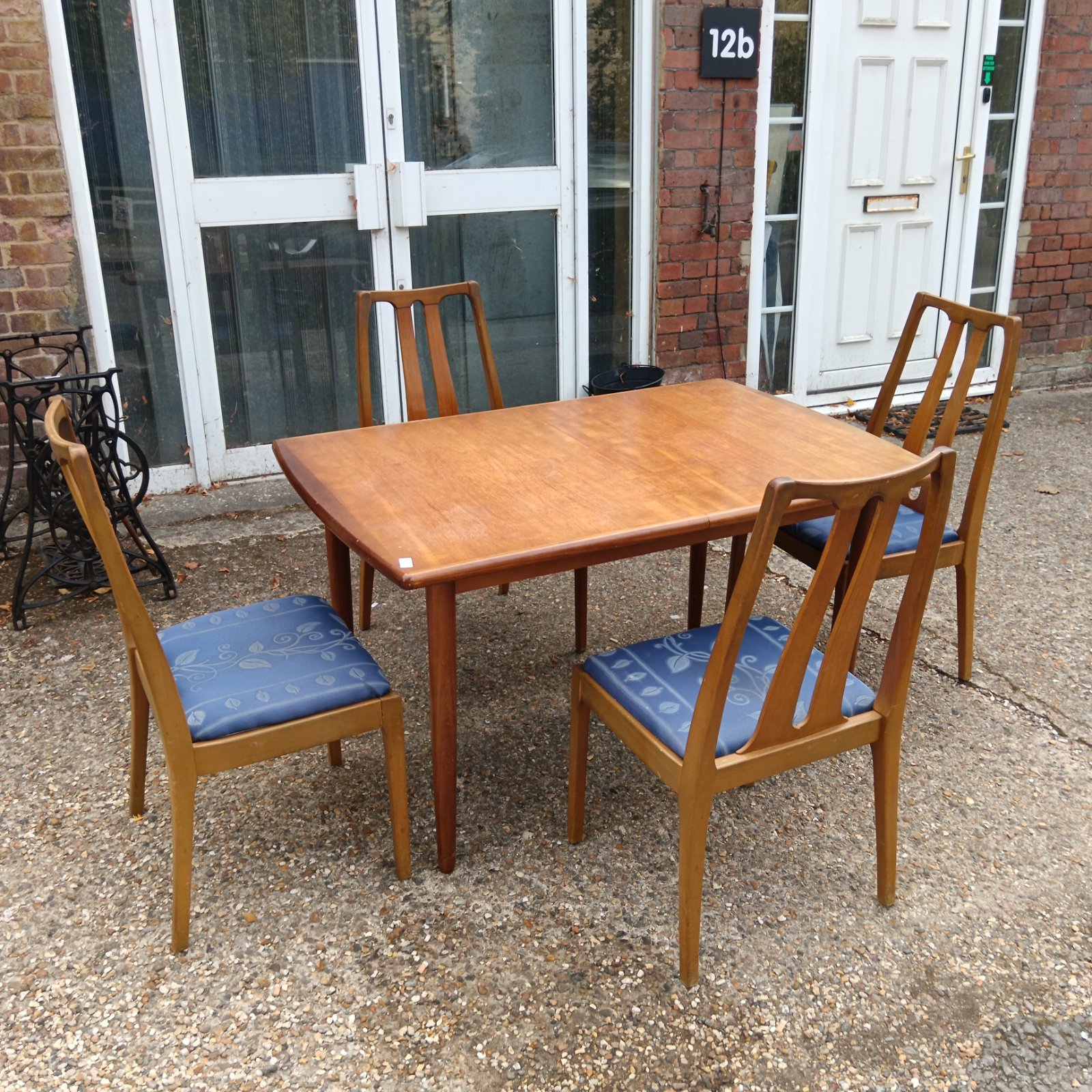 Mid century dining set with teak table and patterned chairs.