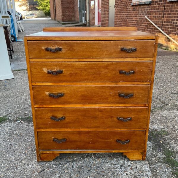 Mid century five drawer chest of drawers in wood.
