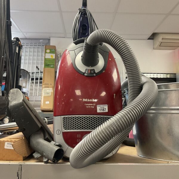 Red Miele C2 Cat & Dog cylinder vacuum cleaner with hose.