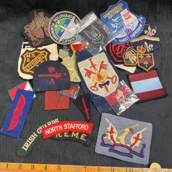 Assorted military cloth badges, including RAF and WWII patches.