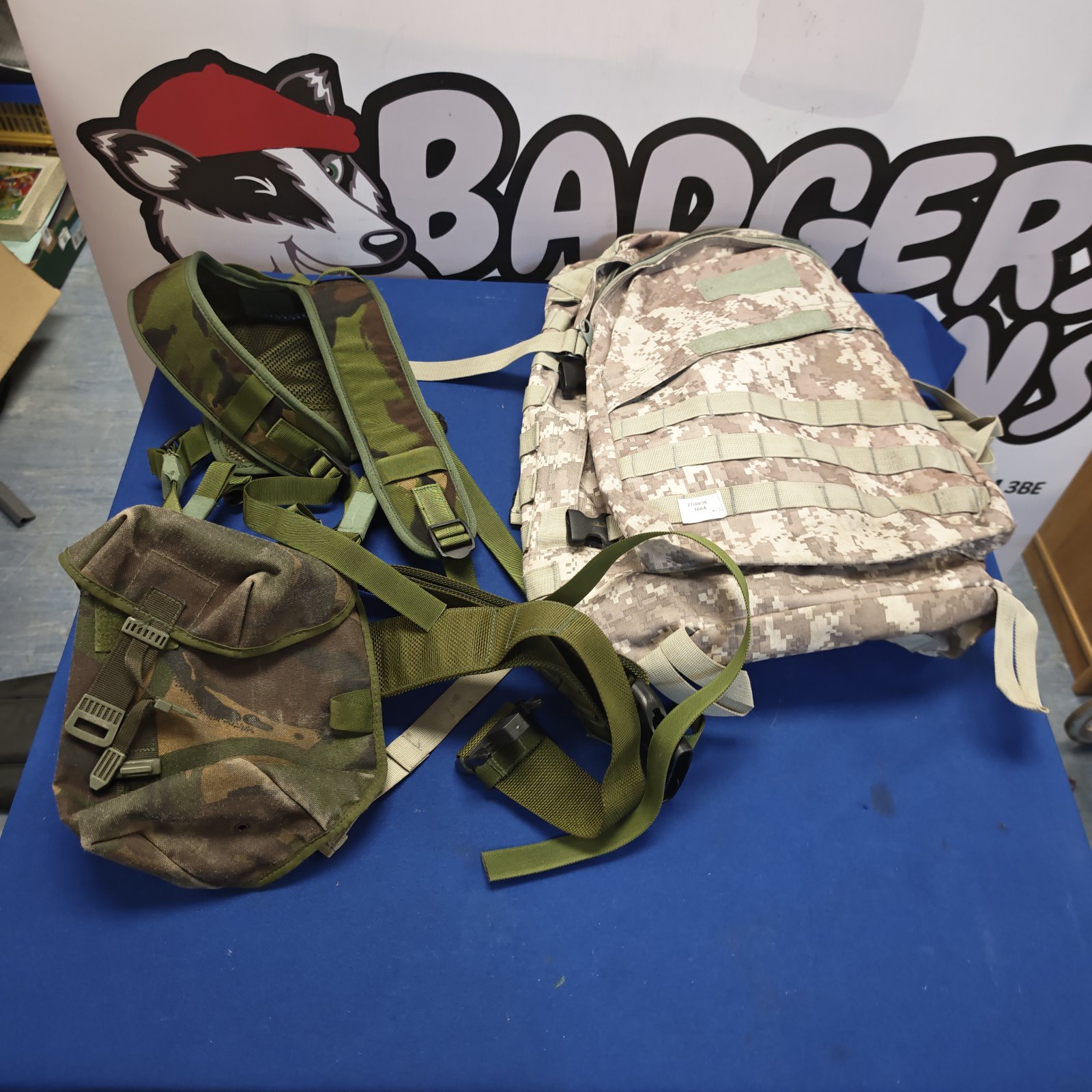 Desert camouflage military rucksack with British forest pouch vest.