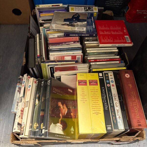 Mixed lot of DVDs and CDs with box sets for entertainment.