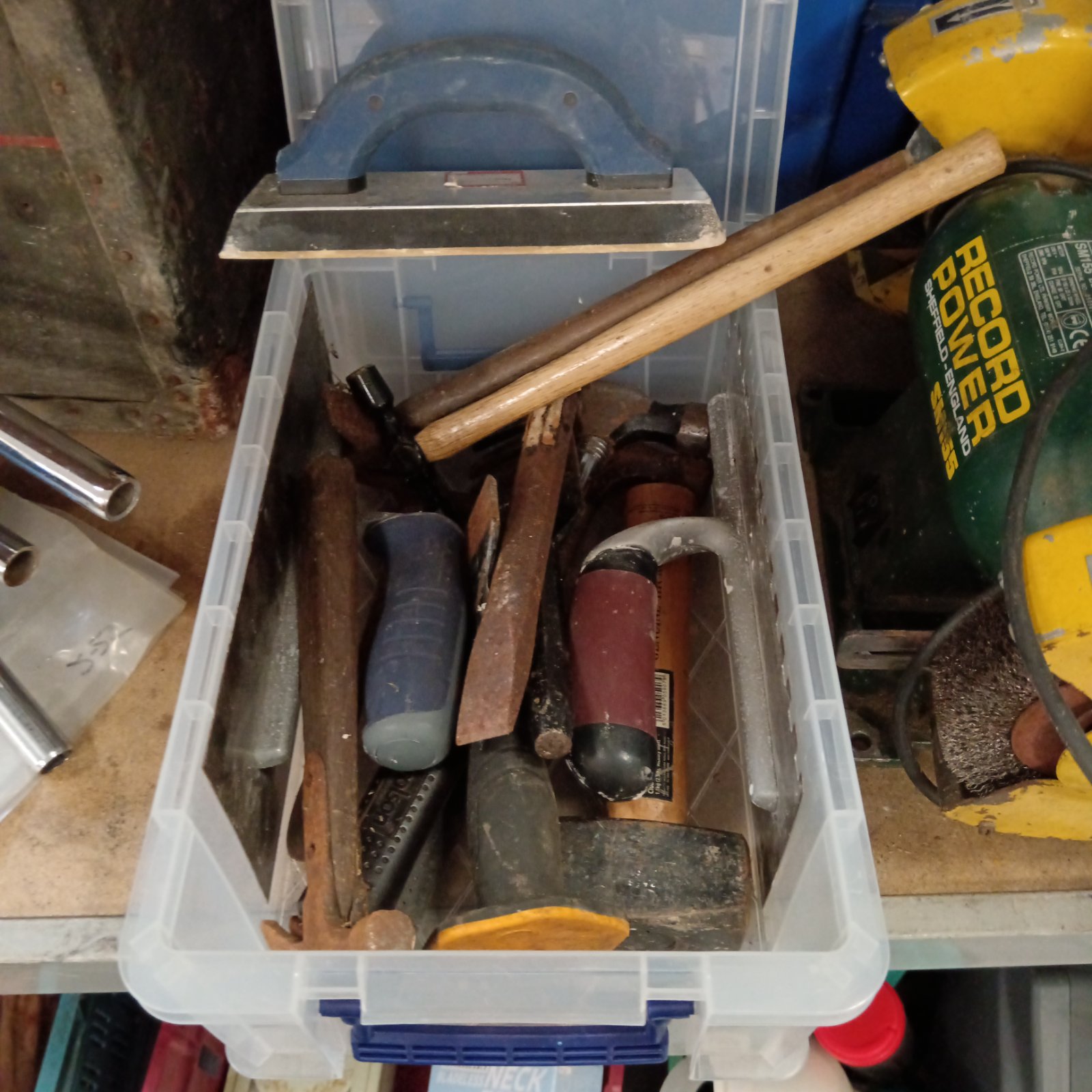 Mixed tool lot featuring several hammers in a plastic container.