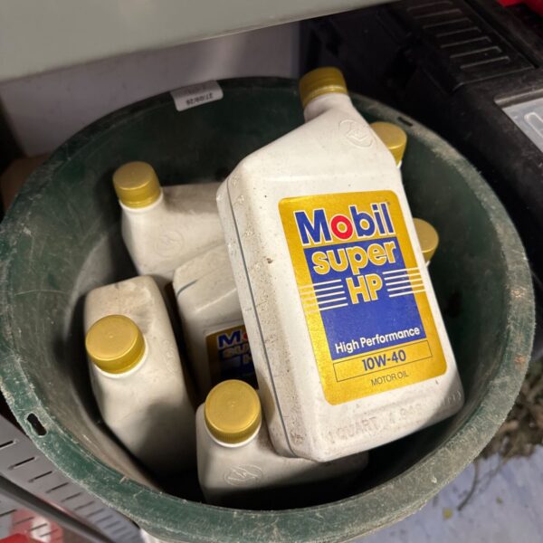 Seven bottles of Mobil Super HP 10W40 engine oil, classic automotive branding.