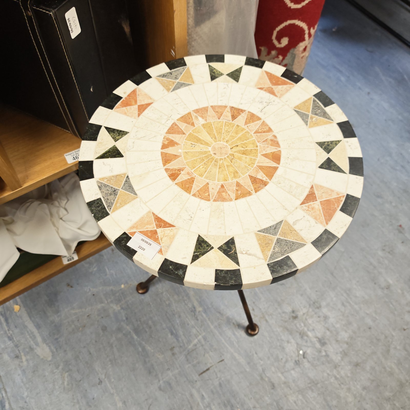 Colourful mosaic garden table with a detailed tile pattern.