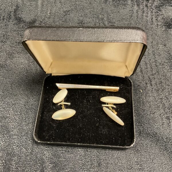 Vintage mother of pearl cufflinks and tie clip set for formal wear.