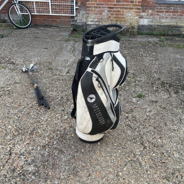 Used Motocaddy golf bag with multiple pockets and visible wear.