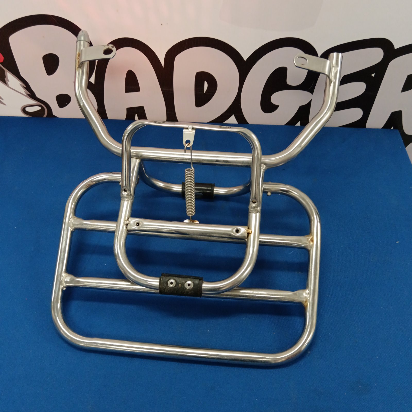Chrome motorcycle luggage rack for carrying items.