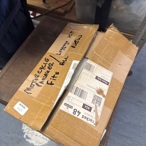 New motorcycle pannier rack kit in original packaging.