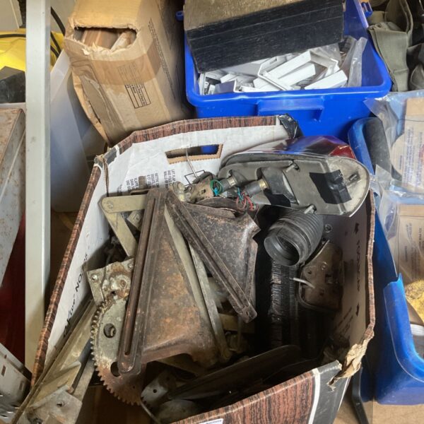 Assorted motorcycle parts in a cardboard box.