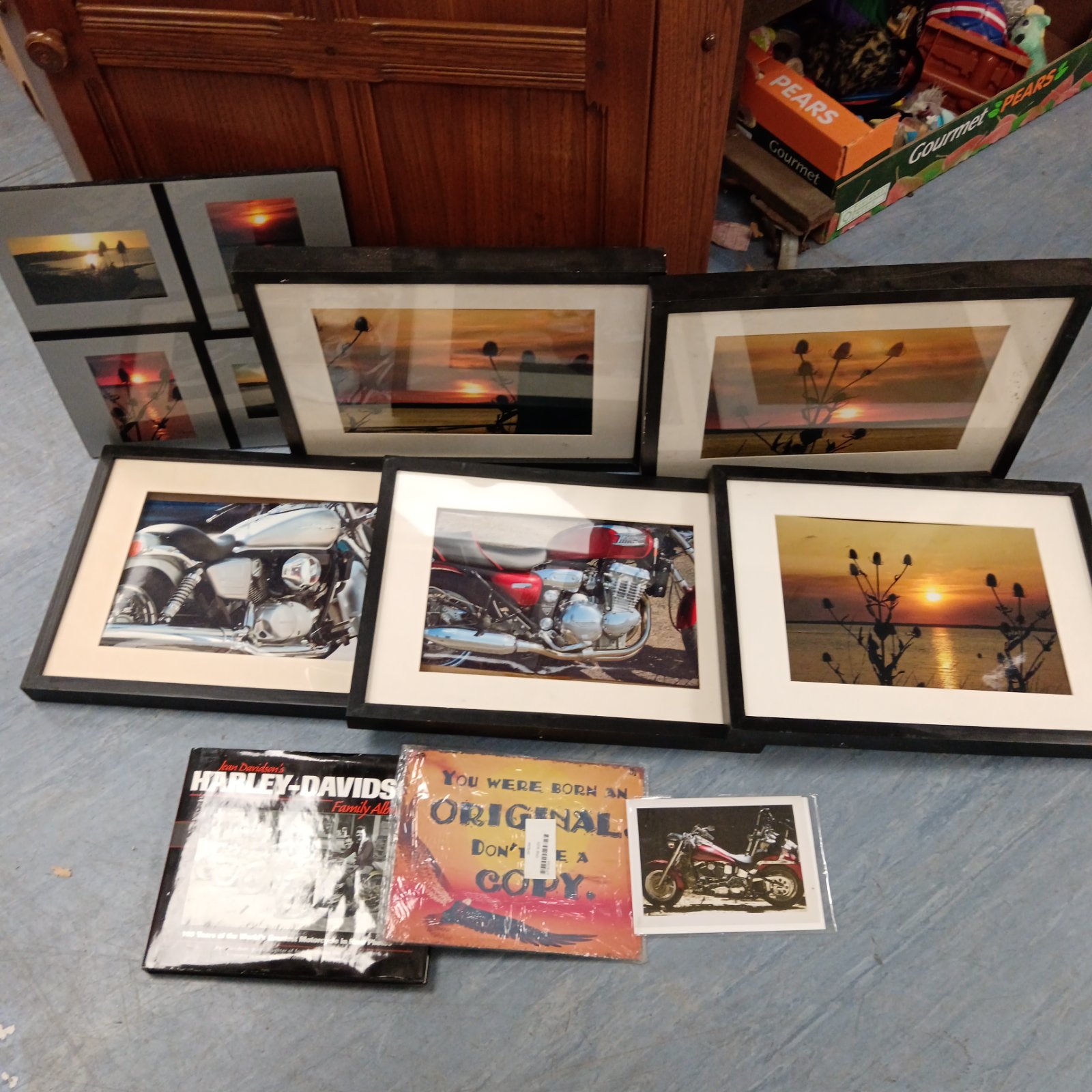 Framed motorcycle photographs, vintage automotive art collection.