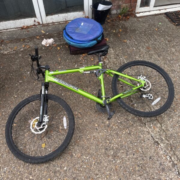 Green Muddyfox mountain bike with full suspension.