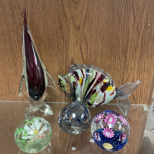 Vibrant Murano glass fish sculpture and floral paperweight collection.
