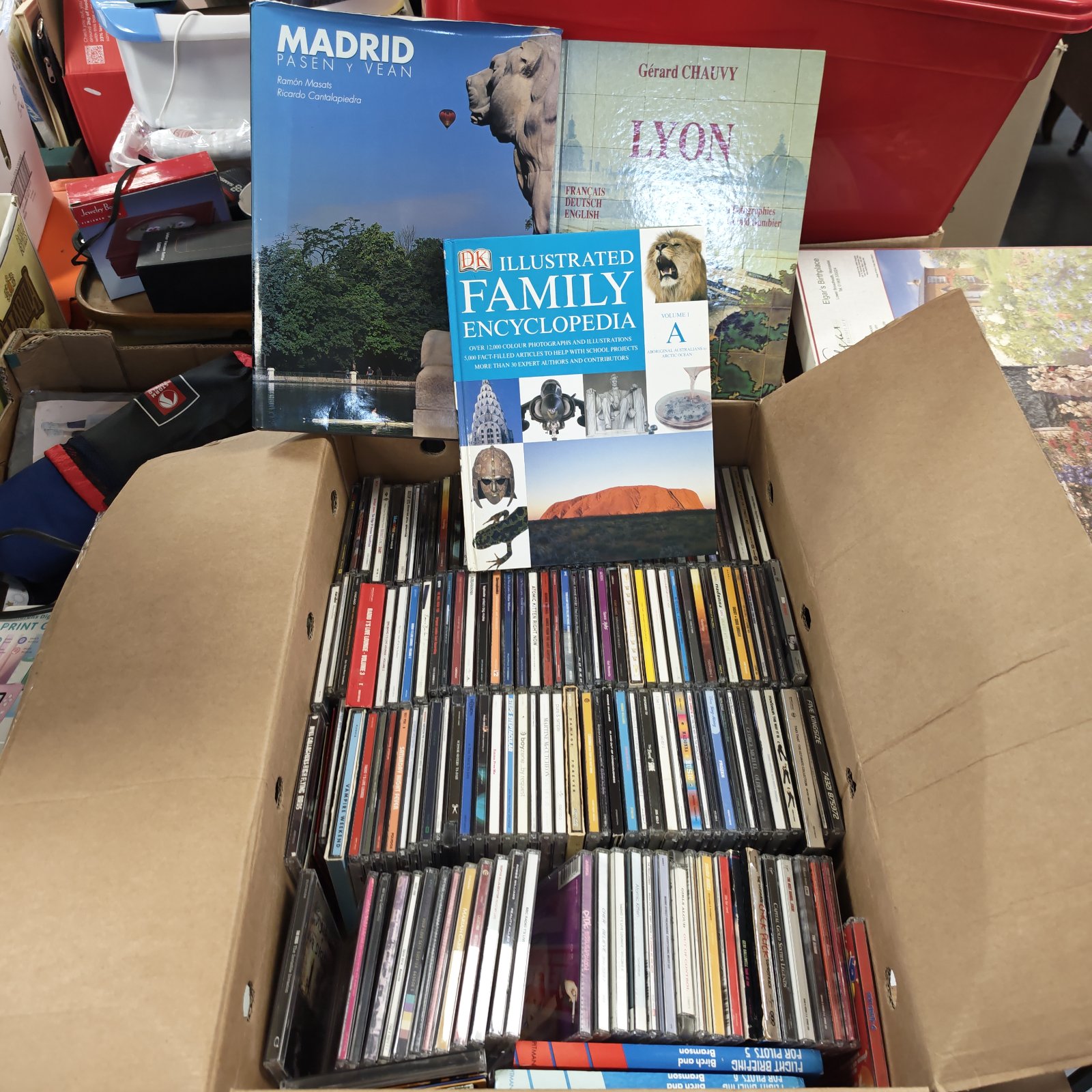 Box of music CDs including Take That and Manic Street Preachers albums.