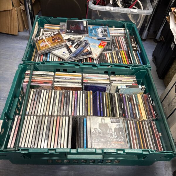 Mixed music CD collection in plastic crates.
