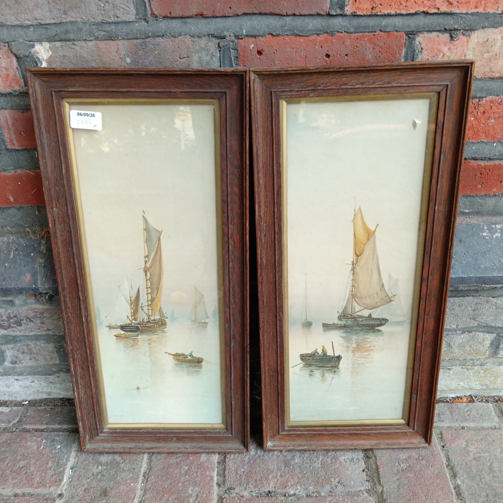 Pair of vintage nautical prints in oak frames, coastal seascape art.