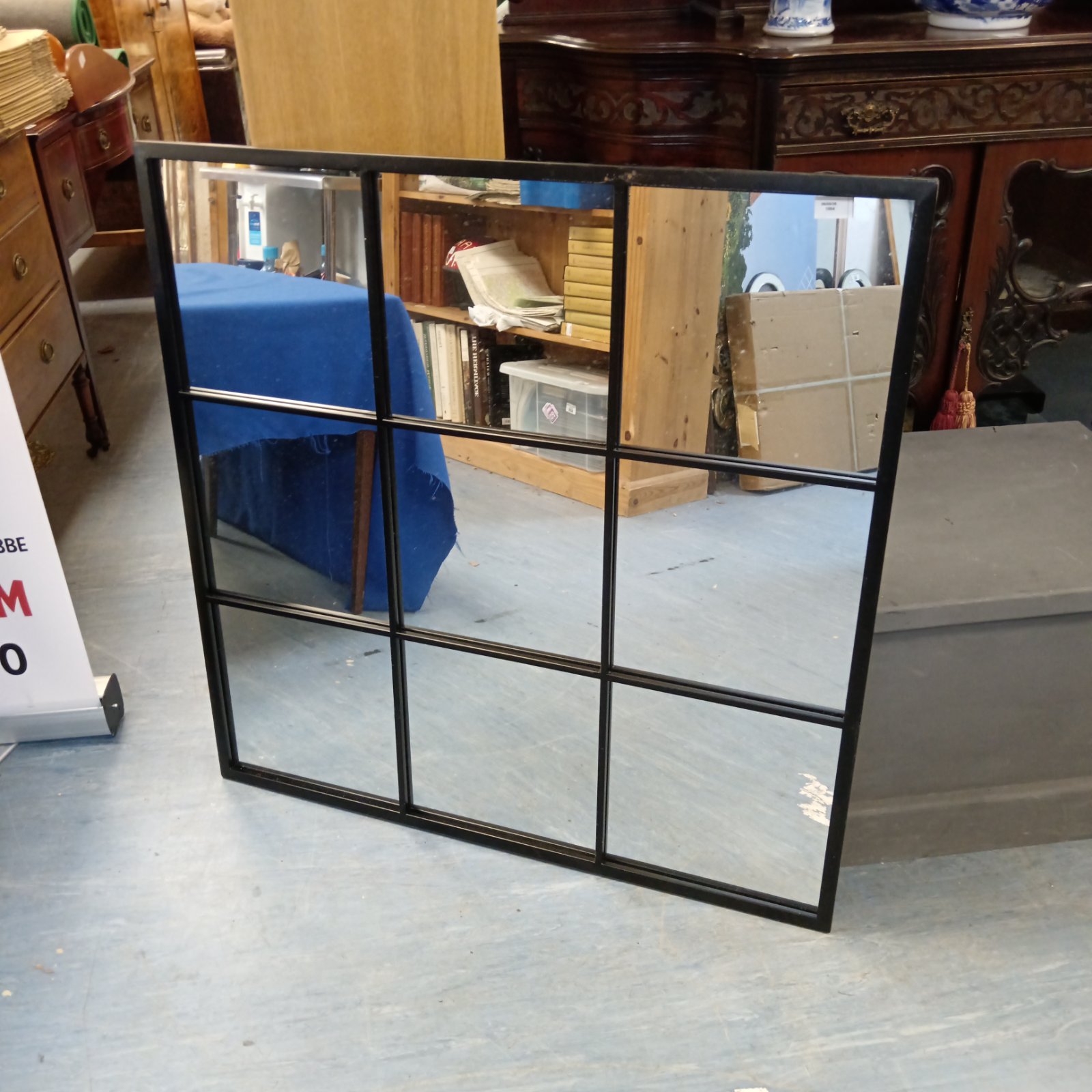 Large nine-panel mirror with a metal frame, ideal for home decor.