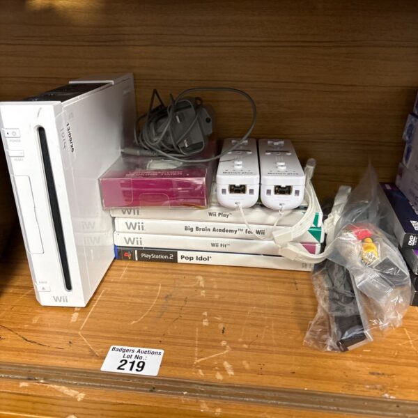 Nintendo Wii console with games and accessories displayed.