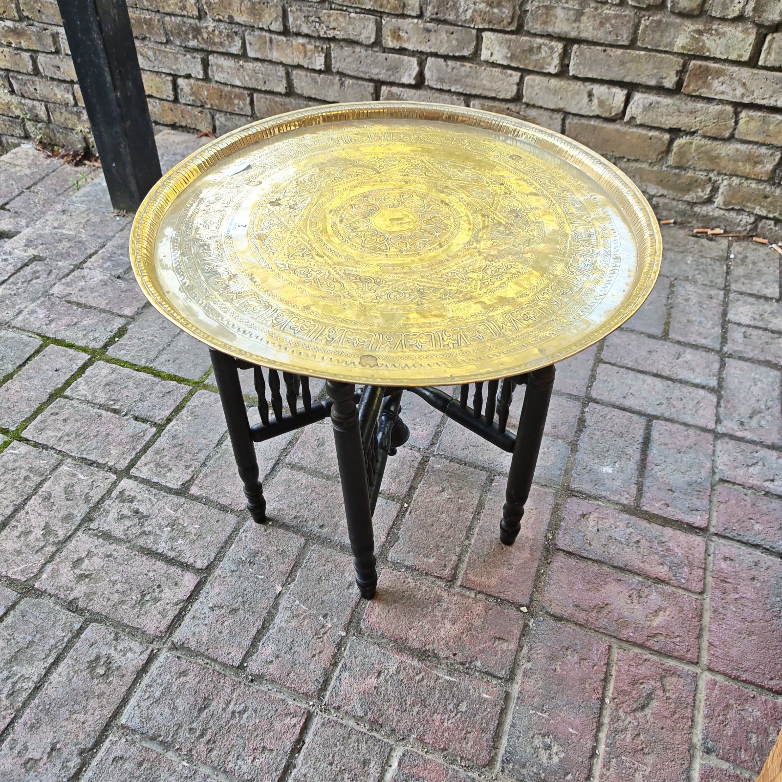 Intricate North African brass coffee table with embossed tray.