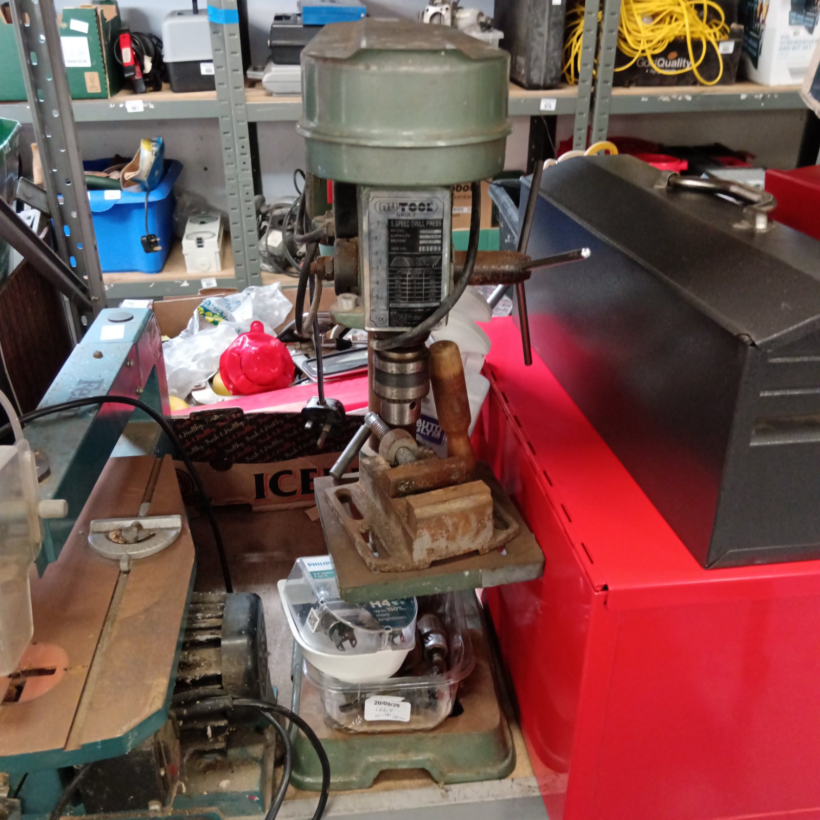 Vintage Nutool pillar drill in a workshop setting.