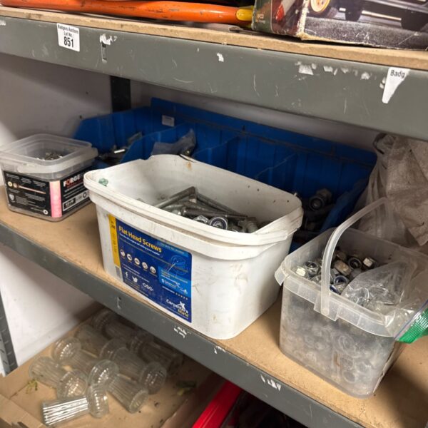 Job lot of assorted nuts, bolts and screws in a plastic container.