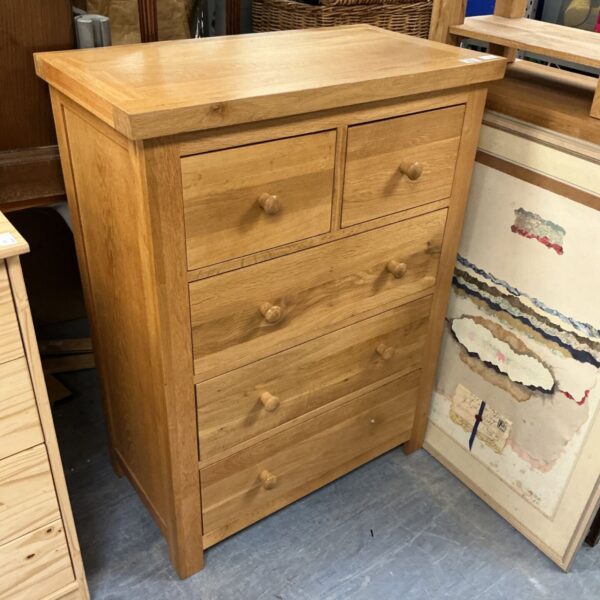 Solid oak chest of drawers with two over three drawers.